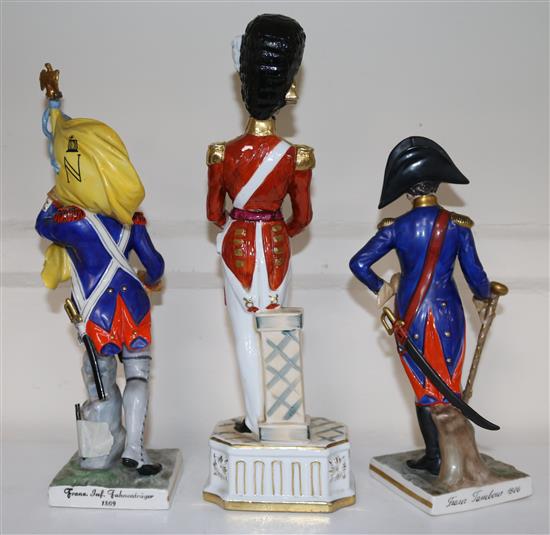 Two German porcelain models of Napoleonic soldiers and another of officer of the Grenadier Guards, 24cm - 31.5cm